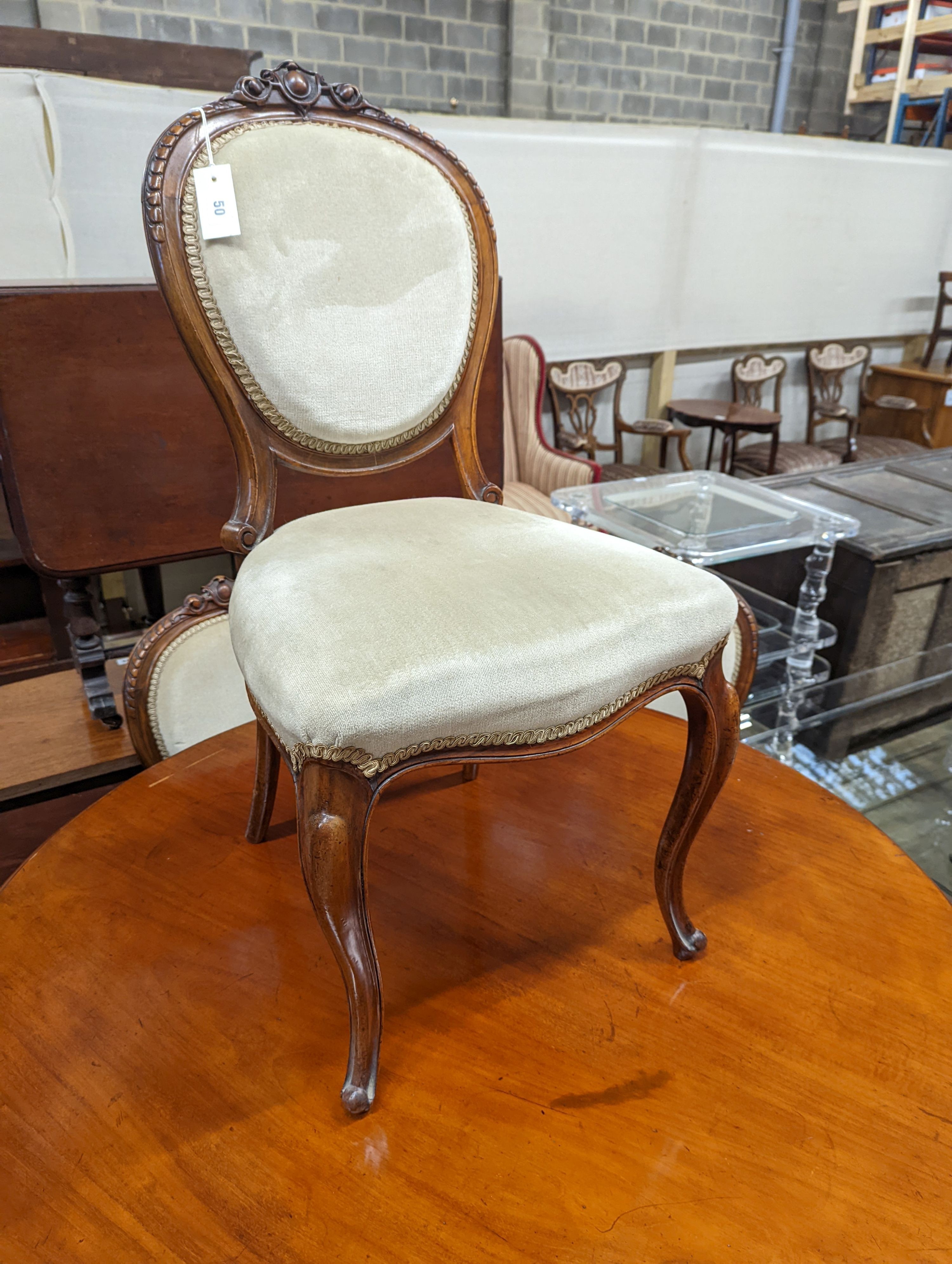 A set of six Victorian mahogany upholstered balloon back dining chairs together with a Victorian mahogany circular breakfast table, diameter 118cm, height 72cm